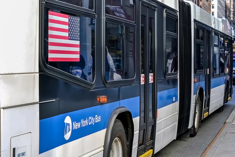 Close-up from back of blue and white New York City bus